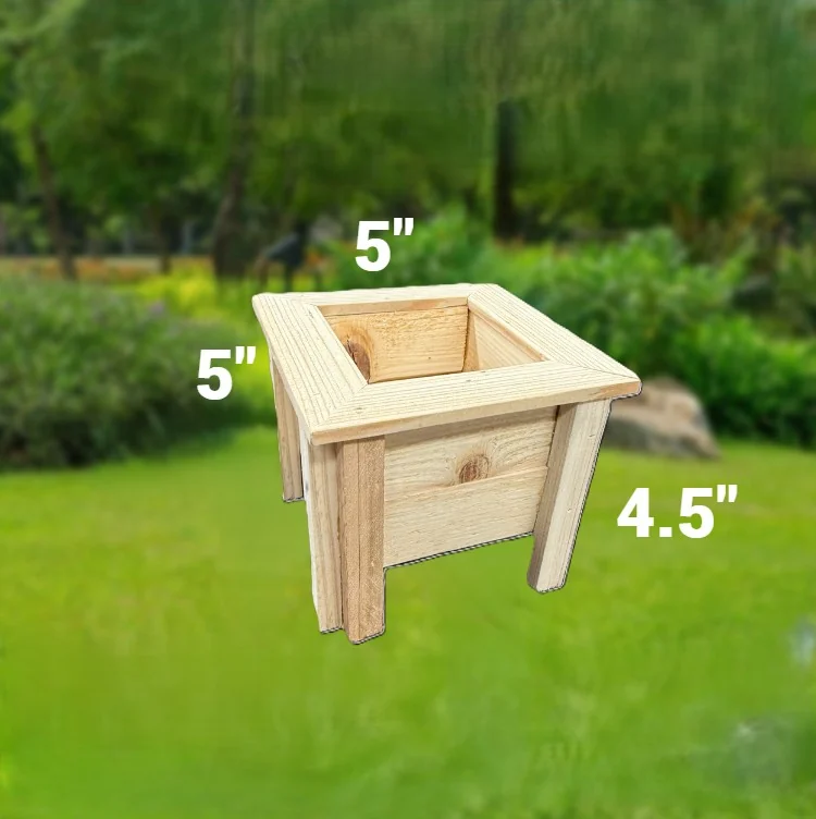 Small square wooden planter box with corner legs, sitting on grass.
